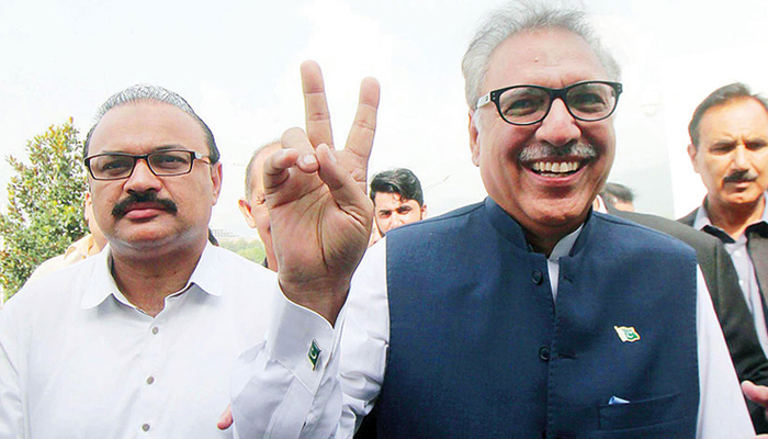 Pakistan Tehreek-e-Insaf’s Dr Arif Alvi flashes the victory sign upon arrival at Parliament House for presidential election in this 2018 Online photo.