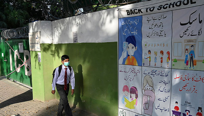 A Student Wearing A Facemask Walks By A Closed School Sealed By Authorities After Some Staffers And Students Tested Positive For The Covid-19 In Islamabad. Photo: Afp/File
