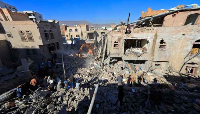 Yemenis inspect the damage following overnight air strikes by the Saudi-led coalition targeting the Huthi rebel-held capital Sanaa, on January 18, 2022. The Saudi-led coalition fighting Yemens Houthi insurgents said it had launched air strikes targeting the rebel-held capital Sanaa after a deadly attack against coalition ally Abu Dhabi. -AFP