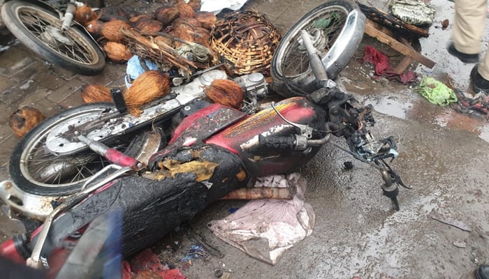 A burnt motorcycle can be seen at the site of the blast near Lohari Gate area in Lahore on January 20, 2021. — Twitter