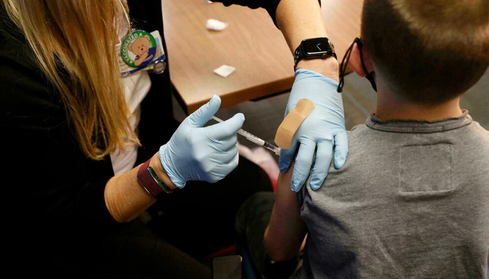 An eight-year-old child receives the Pfizer-BioNTech Covid-19 vaccine at the Beaumont Health offices in Southfield, Michigan, US on November 5, 2021. — AFP