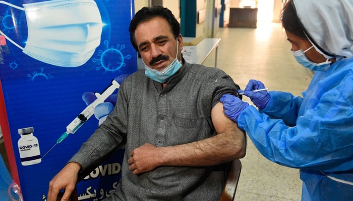 A doctor receives a dose of the Chinese-made Sinopharm COVID-19 vaccine at a vaccination center in Quetta, Pakistan, on February 3, 2021. — AFP