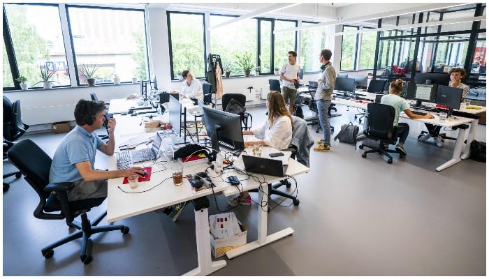 Employees at the online supermarket Picnic are seen at their desks in their office in Duivendrecht — Netherlands OUT / AFP / ANP / Jeroen JUMELET