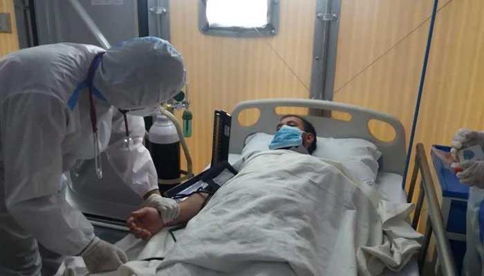 A patient suffering from COVID-19 is being treated by the paramedics staff at a hospital. — AFP/File