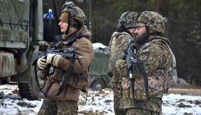 In this image released by he US Department of Defense, two NATO supply soldiers prepare to move to the location of their next mission during Allied Spirit 22 military exercise on January 31, 2022, at Joint Multinational Readiness Center, Hohenfels Training Area, Germany.-AFP