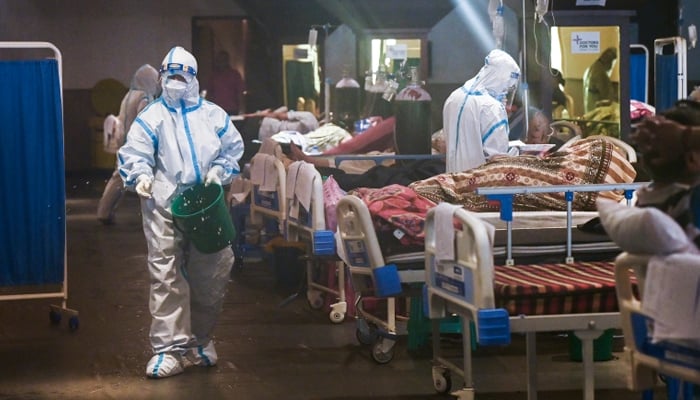 Health workers wearing personal protective equipment (PPE) attend to patients inside a banquet hall temporarily converted into a coronavirus ward in New Delhi. — AFP/File