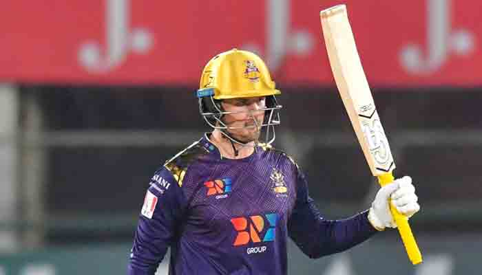 Quetta Gladiators Jason Roy raises his bat after scoring a century in his match of the PSL 2022. -Photo PCB