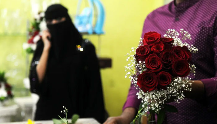 A florist prepares a Valentine’s Day bouquet of flowers for a Saudi client at a flower shop in Jeddah on February 14, 2018. AFP