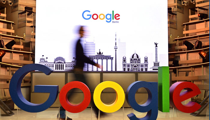This file photo taken on January 22, 2019 shows a technician passing by a logo of US internet search giant Google during the opening day of a new Berlin office of Google in Berlin. — AFP/File