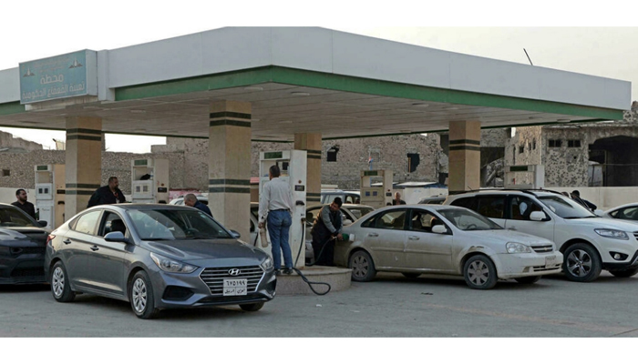 Iraqis wait in a queue at a petrol station in the northern city of Mosul to fill up their cars amid shortages authorities say are due to smuggling to neighbouring Kurdistan. — AFP