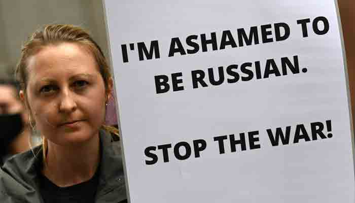 A protester holds a placard during a demonstration against the Russian invasion of Ukraine in Sydney on February 25, 2022. -AFP