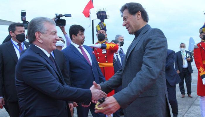 Prime Minister Imran Khan (R) receives Uzbekistans President Shavkat Mirziyoyev (L) at Noor Khan Airbase. — PID