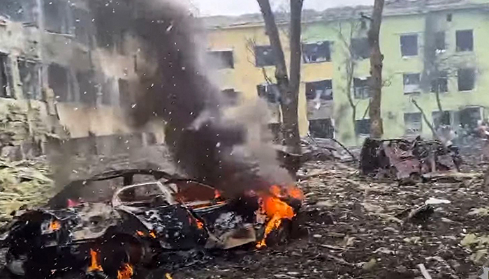 This video grab from handout footage taken and released by the National Police of Ukraine on March 9, 2022, shows damaged buildings of a childrens hospital, destroyed cars and debris on the ground following a Russian airstrike in the southeastern city of Mariupol. — AFP