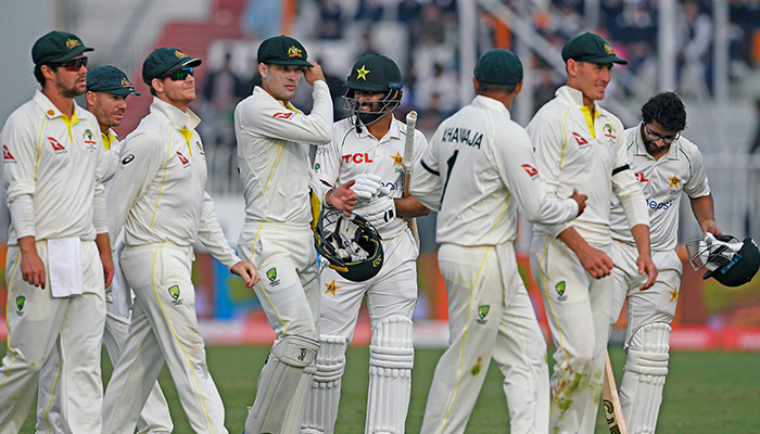 Players of Pakistans and Australias leave the ground after a draw in the first Test cricket match between Pakistan and Australia at the Rawalpindi Cricket Stadium in Rawalpindi on March 8, 2022. — AFP