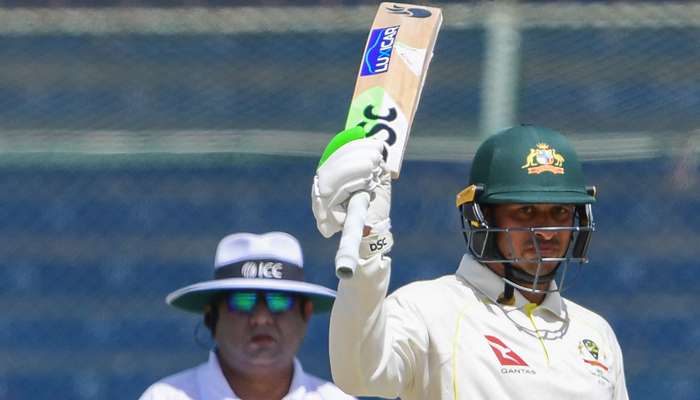 Australias Usman Khawaja raises his bat after scoring 150 runs during the second day of the second Test cricket match between Pakistan and Australia at the National Cricket Stadium in Karachi on March 13, 2022. Photo: AFP