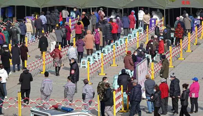 People queue to undergo tests for COVID-19 in Yantai, China. Photo: AFP/file