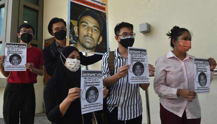 Activists hold posters against the execution of Nagaenthran Dharmalingam, sentenced to death for trafficking heroin into Singapore, outside the Singapore High Commission in Kuala Lumpur on March 9, 2022. — AFP/File