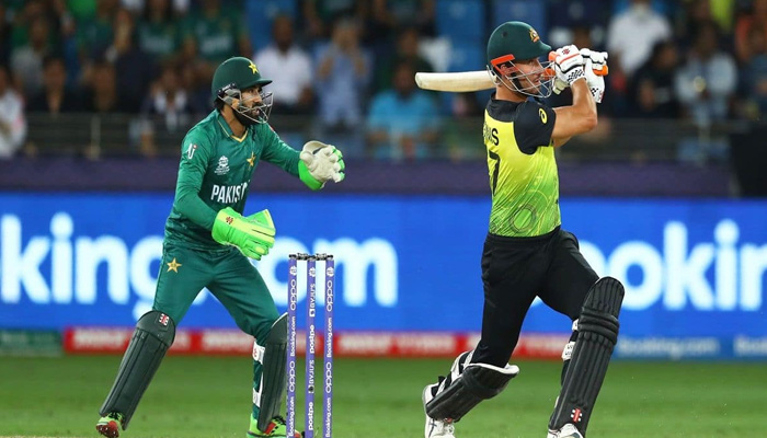 An Australian batter plays a shot as Pakistans Mohammad Rizwan looks on. -The News/File