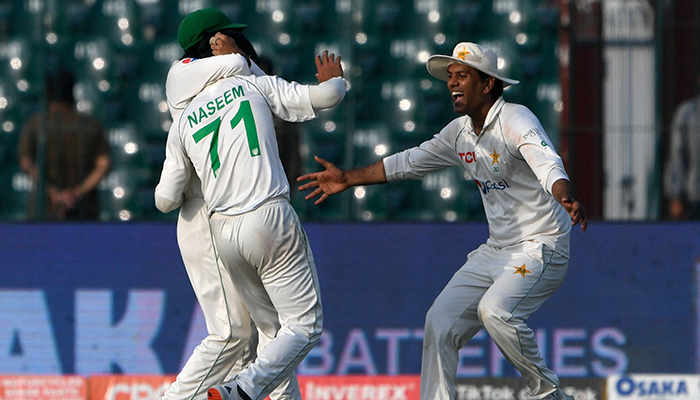 Pakistans Naseem Shah (C) celebrates with teammates after taking the wicket of Australias Travis Head (not pictured) during the first day of the third and final Test cricket match between Pakistan and Australia at the Gaddafi Cricket Stadium in Lahore on March 21, 2022. — AFP