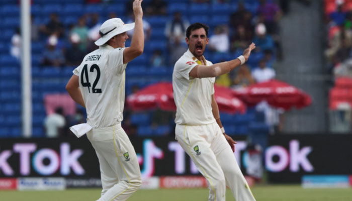 Australias Mitchell Starc (R) celebrates with teammates after dismissing Pakistans Babar Azam during the third day of the third cricket Test match between Pakistan and Australia. — AFP