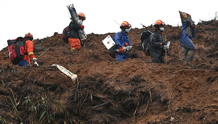 Rescue workers comb through the site of where China Eastern flight MU5375 crashed on March 21, near Wuzhou in southwestern Chinas Guangxi province on March 24, 2022. — AFP