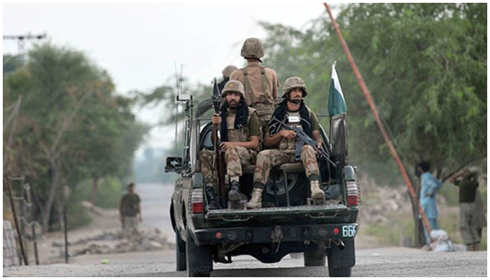 Armed security forces personnel ride on an army van. — AFP/File