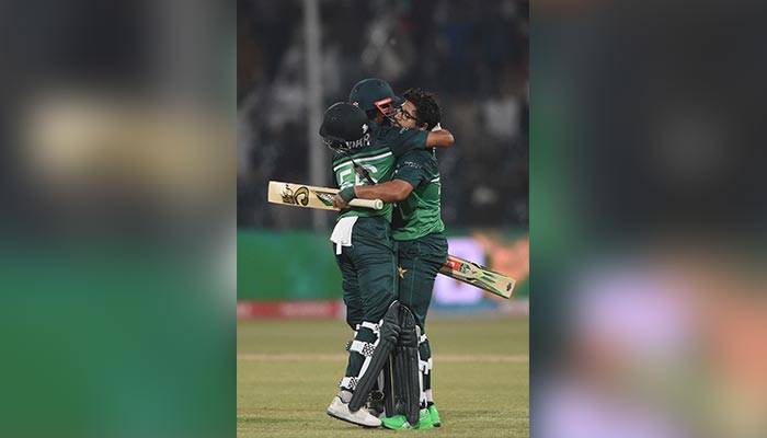 Pakistans Imam-ul-Haq (R) celebrates with teammate Babar Azam (L) after scoring a century (100 runs) during the second one-day international (ODI) cricket match between Pakistan and Australia at the Gaddafi Cricket Stadium in Lahore on March 31, 2022. — AFP