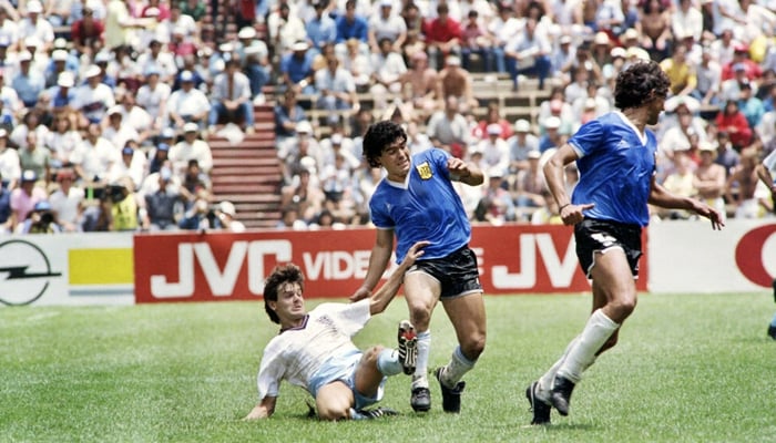 Diego Maradona (center) battles English midfielder Steve Hodge (on the ground) on June 22, 1986 during the World Cup quarterfinal in Mexico City won by Argentina against England. — AFP