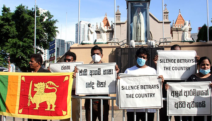Catholics hold placards as they take part in a protest outside a church in Colombo on April 9, 2022. — AFP