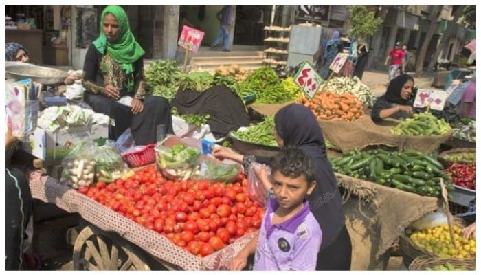 Women selling vegetables in Egypt. — AFP