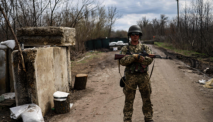 Ukrainian servicemen stand guard at a checkpoint on the outskirts of Barvinkove, eastern Ukraine, on April 15, 2022. — AFP