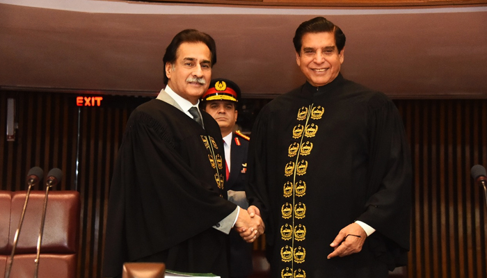 PPP leader and MNA Raja Pervez Ashraf (right) and PML-N leader and MNA Ayaz Sadiq shake hands after Sadiq administers the oath to the newly-elected speaker of the National Assembly in Islamabad, on April 16, 2022. — Twitter/NAofPakistan