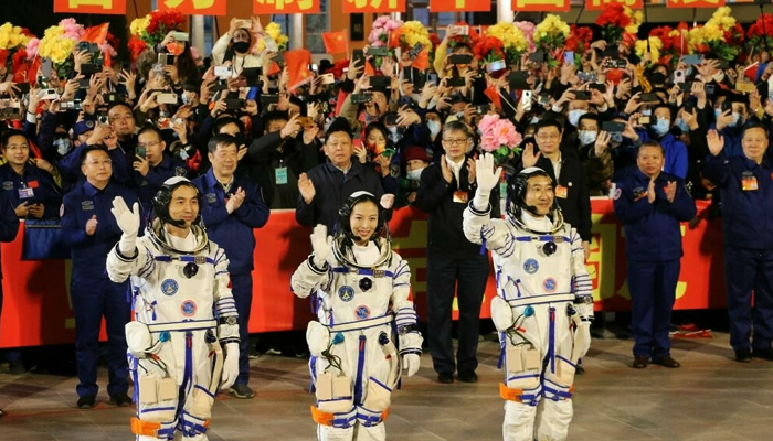 Astronauts Ye Guangfu, Wang Yaping and Zhai Zhigang, wave at a departure ceremony before their launch on the Shenzhou 13 spacecraft in October 2021. — AFP/File
