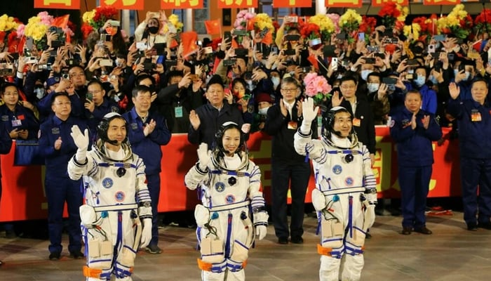 Astronauts Ye Guangfu, Wang Yaping and Zhai Zhigang, wave at a departure ceremony before their launch on the Shenzhou 13 spacecraft in October 2021. — AFP/File