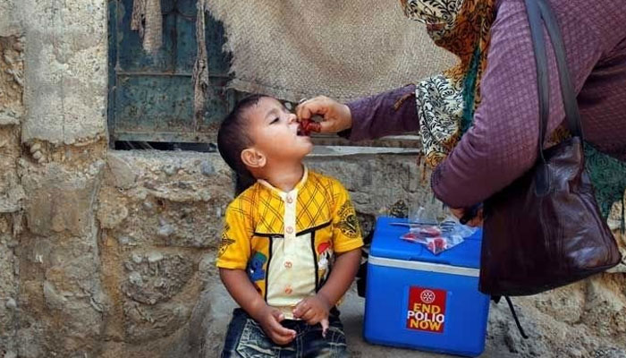 A health worker is administering polio drops to a child. Photo: Geo.tv/ file