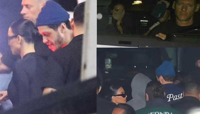 Kim Kardashian and Pete Davidson try to hide their faces as they rush out of the Los Angeles theater