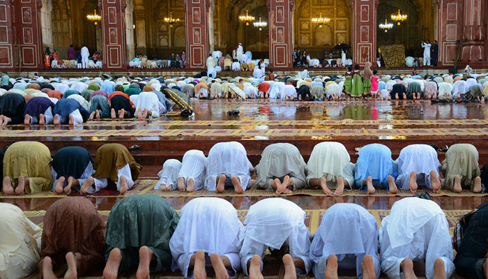 Pakistani Muslim devotees offer Eid prayers on the first day of the Eid ul Fitr festival at Badshahi Masjid in Lahore on July 29, 2014. — AFP