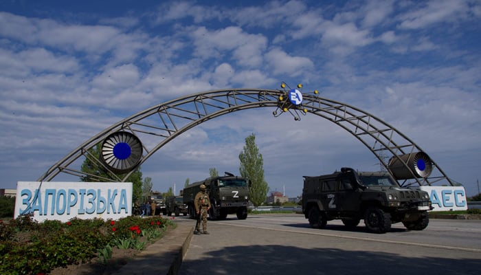 Russian military vehicles drive through the gates of the Zaporizhzhia Nuclear Power Station in Energodar on May 1, 2022. The Zaporizhzhia Nuclear Power Station in southeastern Ukraine is the largest nuclear power plant in Europe and among the 10 largest in the world. -AFP