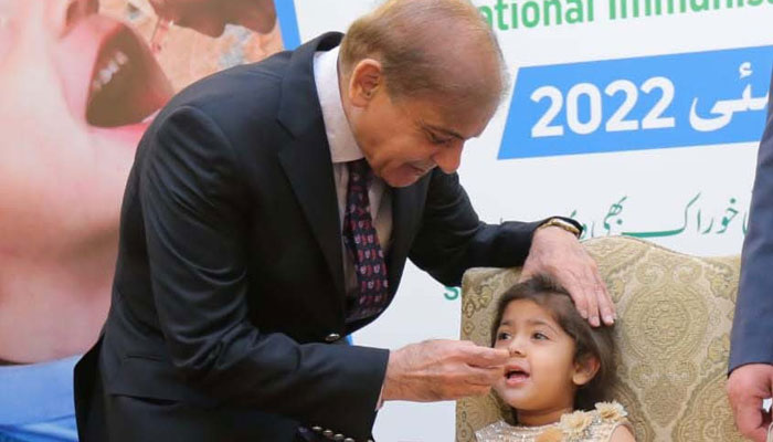 Prime Minister Shahbaz Sharif is administering polio vaccine drops to a child. — PID
