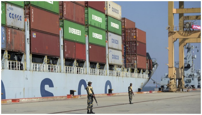 Pakistani Naval personnel stand guard near a ship carrying containers at the Gwadar port, some 700 kms west of Karachi. — AFP/File