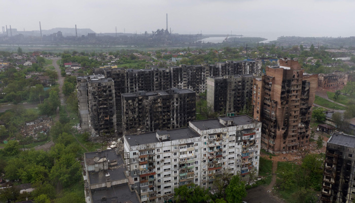An aerial view of damaged residential buildings and the Azovstal steel plant in the background in the port city of Mariupol on May 18, 2022, amid the ongoing Russian military action in Ukraine. -AFP