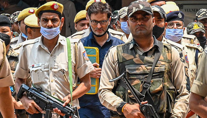 Police and security personnel escort pro-independence party Jammu Kashmir Liberation Front chairman Yasin Malik (C) to holding area after a sentencing hearing at Patiala House court in New Delhi on May 25, 2022. — AFP