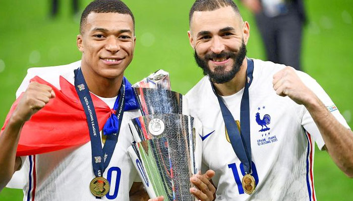France forwards Kylian Mbappe, left, and Karim Benzema celebrate with the UEFA Nations League trophy after beating Spain at the San Siro stadium in Milan, Italy, on Sunday. Photo: AFP