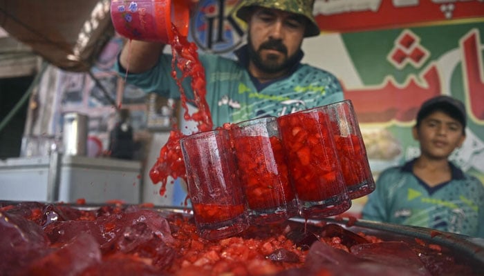 A cooling 115-year-old pink libation with a secret recipe is wildly popular on both sides of the India-Pakistan border. Photo: AFP