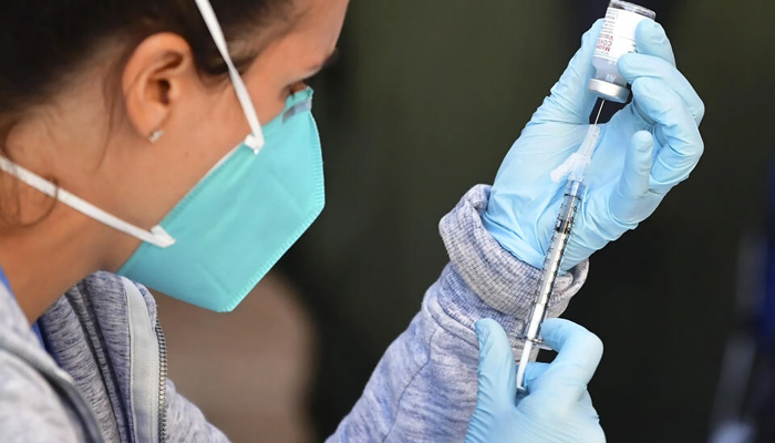 In this file photo from 2021, the Moderna COVID-19 vaccine is loaded into a syringe ahead of injection. — AFP
