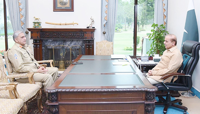 This handout photograph taken on April 19, 2022, and released by the Pakistan Prime Ministers Office shows Prime Minister Shehbaz Sharif (right) speaking with Army Chief General Qamar Javed Bajwa at the Prime Minister House in Islamabad. — AFP