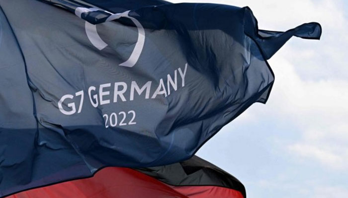 A German national flag and a flag for the G7 Summit fly in the wind in Garmisch-Partenkirchen. Photo: AFP/File