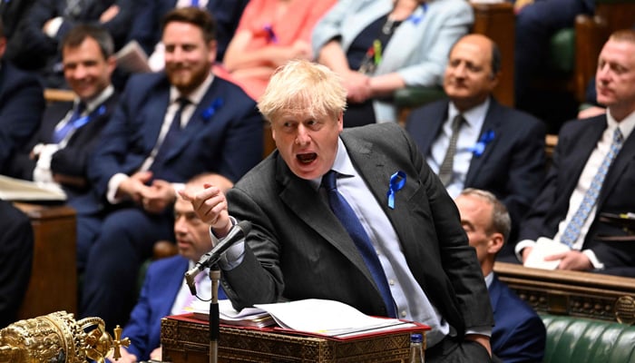 A handout photograph released by the UK Parliament shows Britain´s Prime Minister Boris Johnson gesturing as he speaks during the weekly Prime Minister´s Questions (PMQs) session in the House of Commons, in London, on June 22, 2022.-AFP