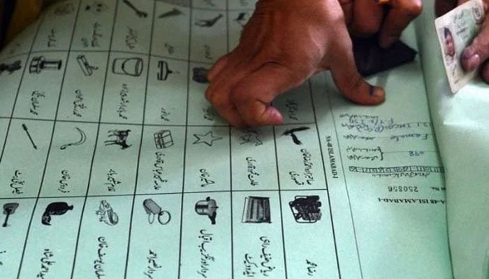 A citizen imprints his thumb impression on a ballot book during polls. — AFP/file