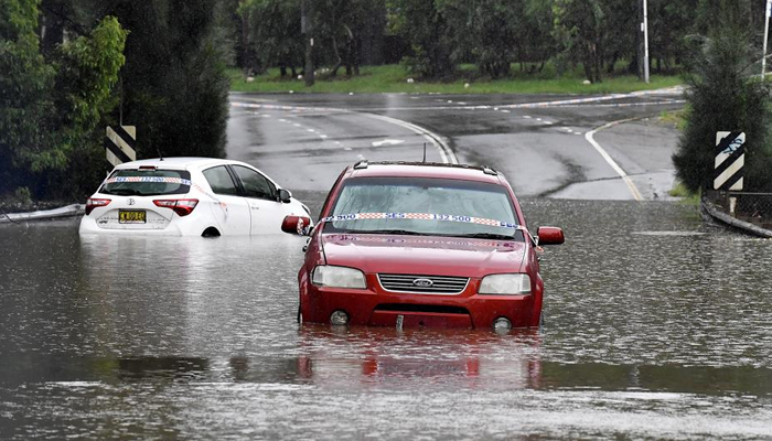 Cars are seen submerged in flood water in the residential area of the southwestern suburb of Sydney on March 8, 2022. — AFP